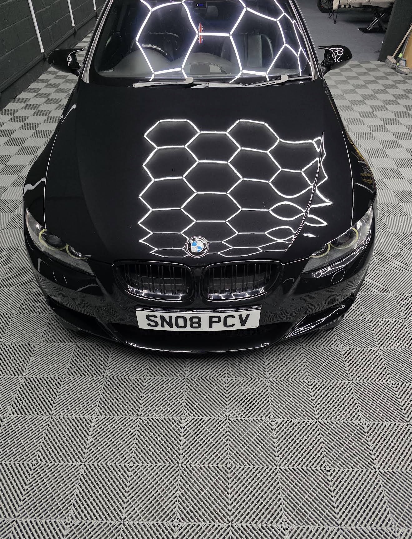 Black BMW bonnet reflecting hexagon lights